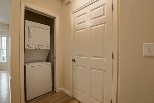 a laundry room with a white door and a washer and dryer