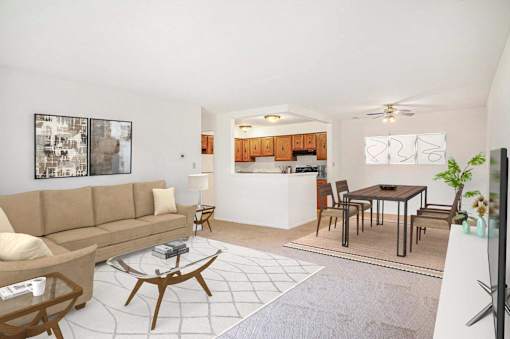 A living room with a brown couch and a coffee table at Hampton in Highland Apartments, Indiana, 46322