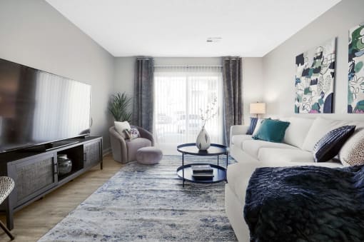 a living room with a white couch and a large tv at Stonewater Apartments, Kentucky