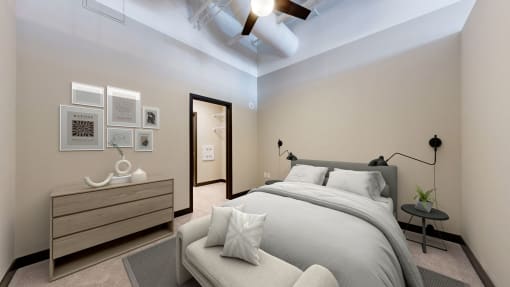 a bedroom with a large bed and a ceiling fan