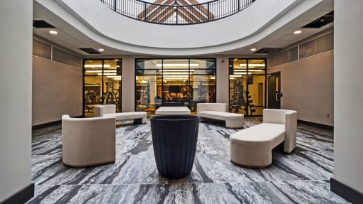 a large lobby with couches and chairs and a table