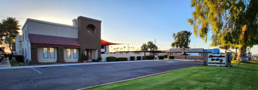 Lush green lawn in front of the leasing office at sunrise