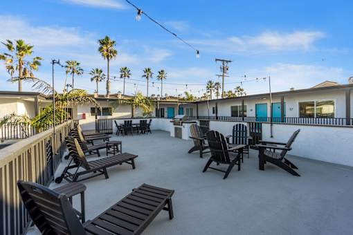 Deck with BBQ and chairs at Ocean Breeze Terrace Apartment, California