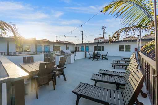 A sunny day at the outdoor seating area of a restaurant at Ocean Breeze Terrace Apartment, Huntington Beach, California
