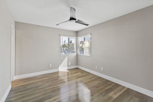 bedroom with ceiling fan at Ocean Breeze Terrace Apartment, Huntington Beach