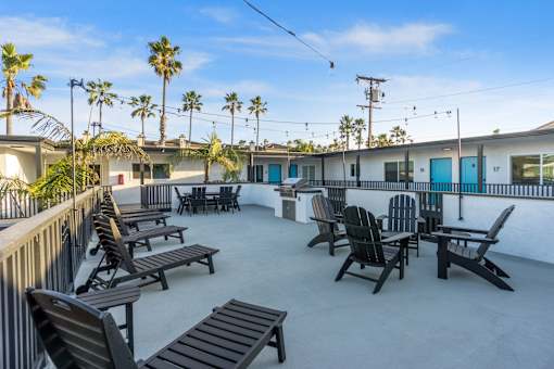 Deck with BBQ and seating at Ocean Breeze Terrace Apartment, Huntington Beach, CA