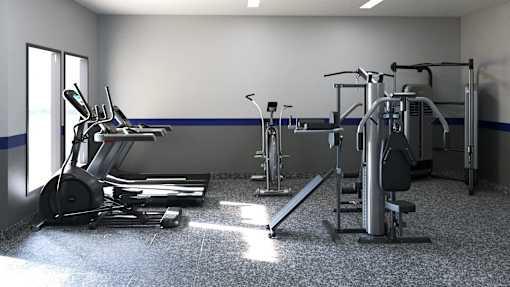 A gym with a variety of equipment including treadmills, weights, and exercise machines.