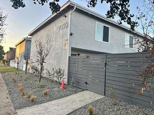 A grey house with the number 1030 on it.