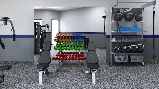 A gym with a variety of equipment including weights and resistance bands.