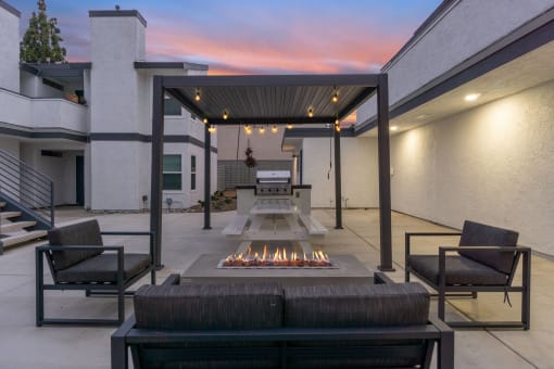 the outdoor patio has a fire pit and seating around it at Hamilton Courtyard Apartments, Costa Mesa, CA, 92627