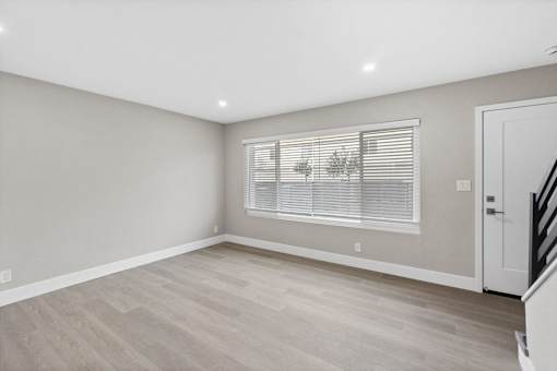 A room with a window and a door.