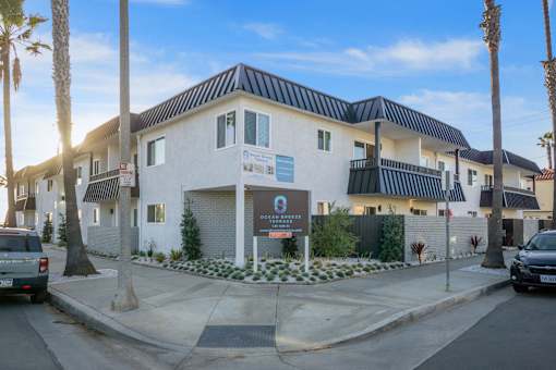 A building with a sign at Ocean Breeze Terrace Apartment, Huntington Beach, CA