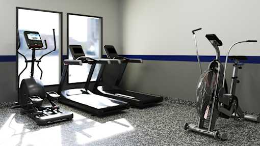 A gym with treadmills, elliptical machines, and a stationary bike.