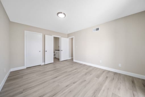 an empty living room with wood floors and white walls at Wescove Apartments, West Covina, CA, 91790