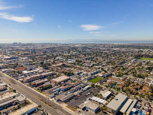 A cityscape with buildings and roads under a clear sky.
