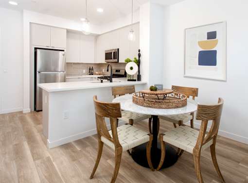 A kitchen with a table and chairs. at The Reserve La Mirada, California, 90638