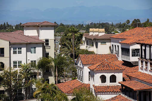 A row of houses with red tile roofs.