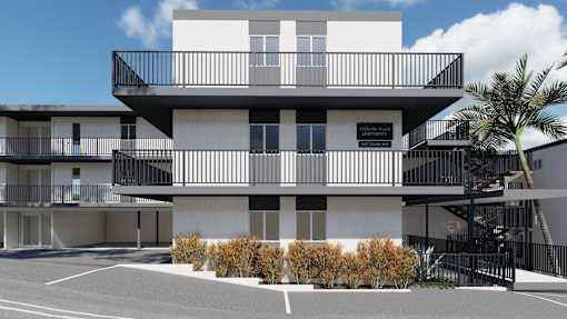 a white apartment building with a parking lot and palm trees