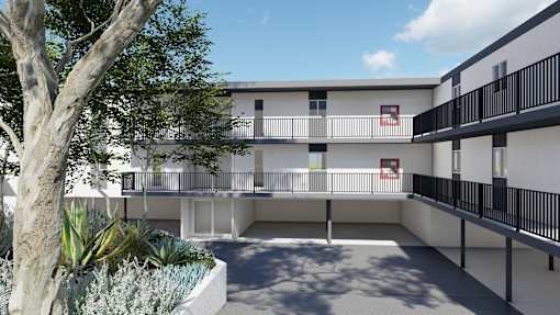 an exterior view of a building with a courtyard and trees