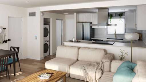 a living room and kitchen with a couch and a table