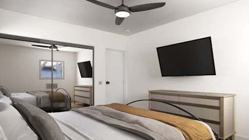 a bedroom with a large bed and a tv on the wall