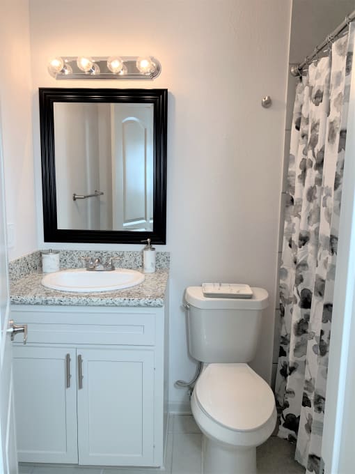 a small bathroom with a toilet sink and mirror