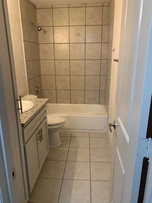 a bathroom with a bathtub and a sink