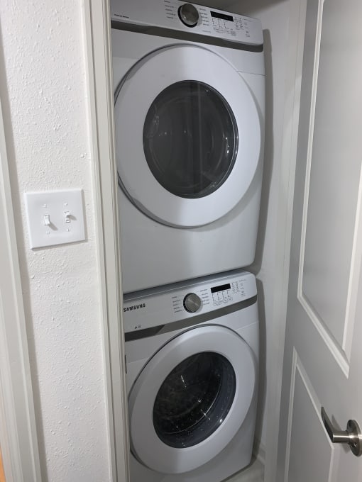 a washing machine and a dryer in a laundry room