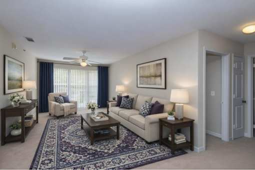 Spacious living room with neutral furnishings at Walnut Ridge Apartments, Raleigh, NC