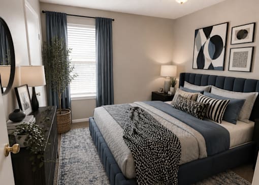 A bedroom with a large bed and a mirror on the wall.