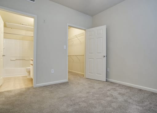 A spacious master bedroom at Addison Park Apartments in Arlington, TX.