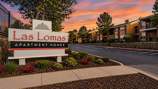 Property entrance sign with landscaping at Las Lomas Apartments, El Paso, 79912