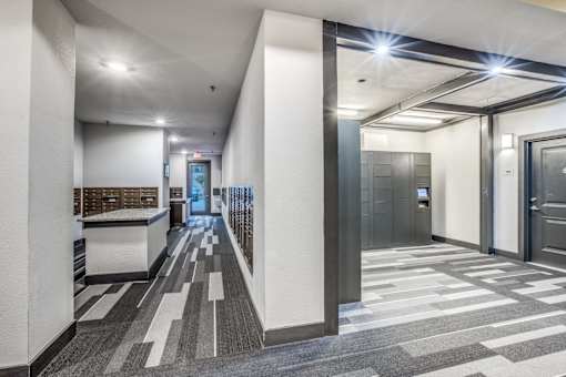 A hallway with a checkered floor and a series of doors on the right.