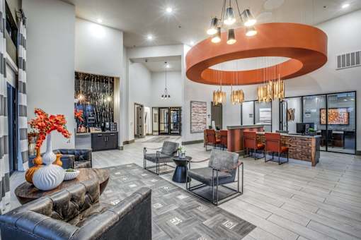 A modern living room with a large circular light fixture and a fireplace.