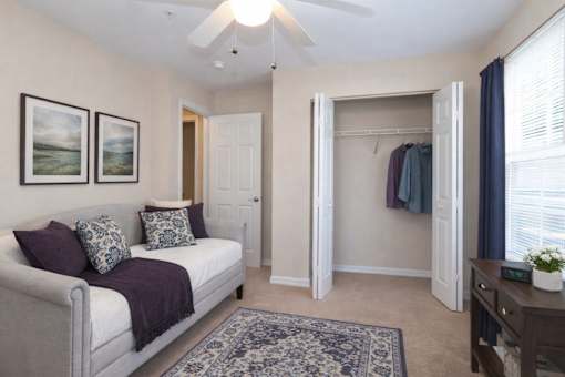 Guest room with daybed and open closet at Walnut Ridge Apartments, Raleigh, NC 27610