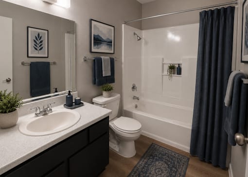 A bathroom with a white toilet and a white sink.