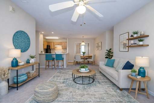 Open concept living room with coastal decor and vaulted ceiling at Walnut Ridge Apartments, Raleigh, North Carolina