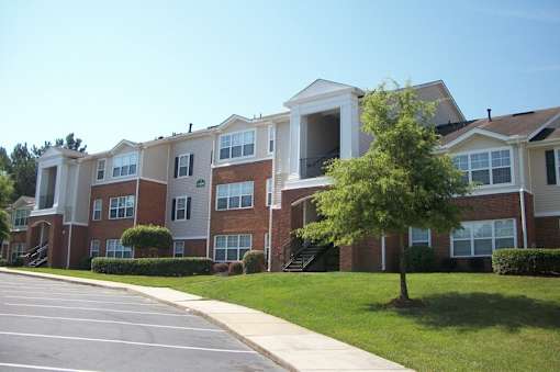 Multistory residential building with brick and siding exterior at Walnut Ridge Apartments, Raleigh, North Carolina