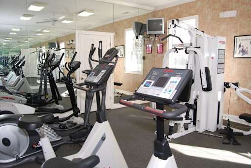 Fitness center with cardio equipment at Walnut Ridge Apartments, North Carolina