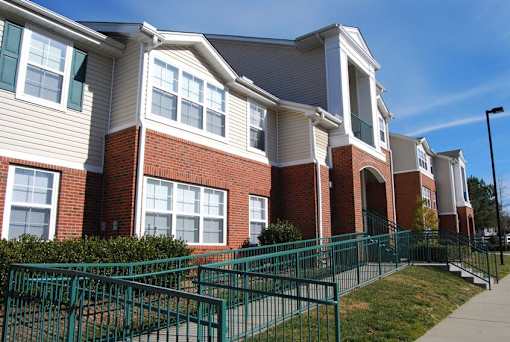 Accessible entrance ramp with metal railings at Walnut Ridge Apartments, Raleigh, NC