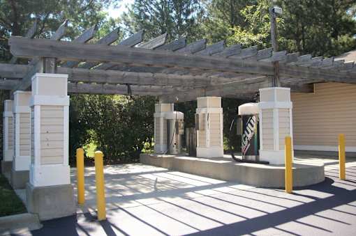 Covered parking structure with wooden pergola beams at Walnut Ridge Apartments, North Carolina, 27610