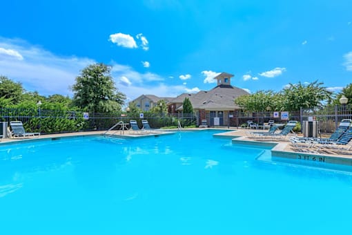 A large swimming pool with a depth of 3 feet 6 inches at Addison Park Apartments in Arlington, TX.