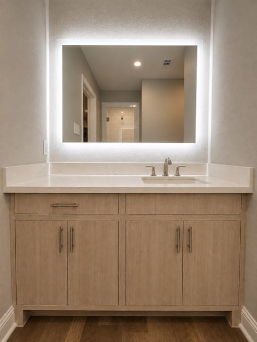 A bathroom with a sink and a mirror above it.