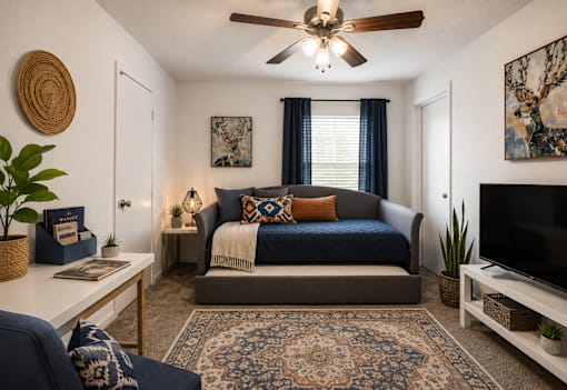 A bedroom with a bed, a ceiling fan, and a rug.