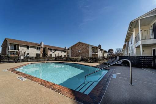 Swimming pool with sundeck and lounge chairs at The Finley Apartments, Dallas, Texas