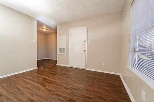Empty living room with hardwood flooring at The Finley Apartments, Texas