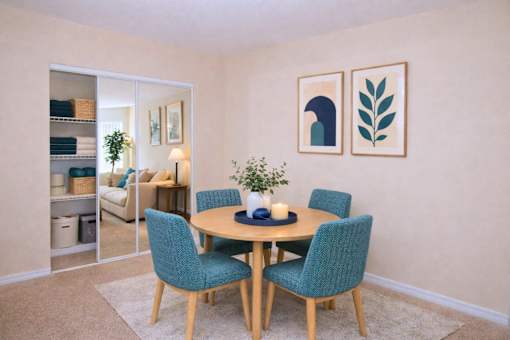 Dining room with round table and modern artwork at Walnut Ridge Apartments, North Carolina