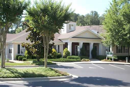 Clubhouse entrance with columned portico and landscaping at Walnut Ridge Apartments, North Carolina, 27610