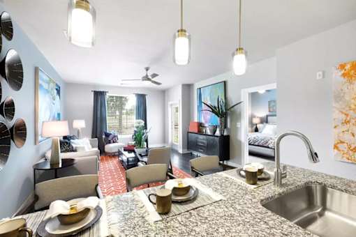 A modern kitchen with a dining table set for two.