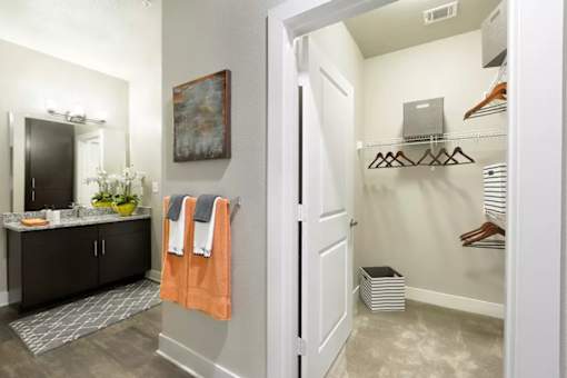 A bathroom with a white door and a grey floor.